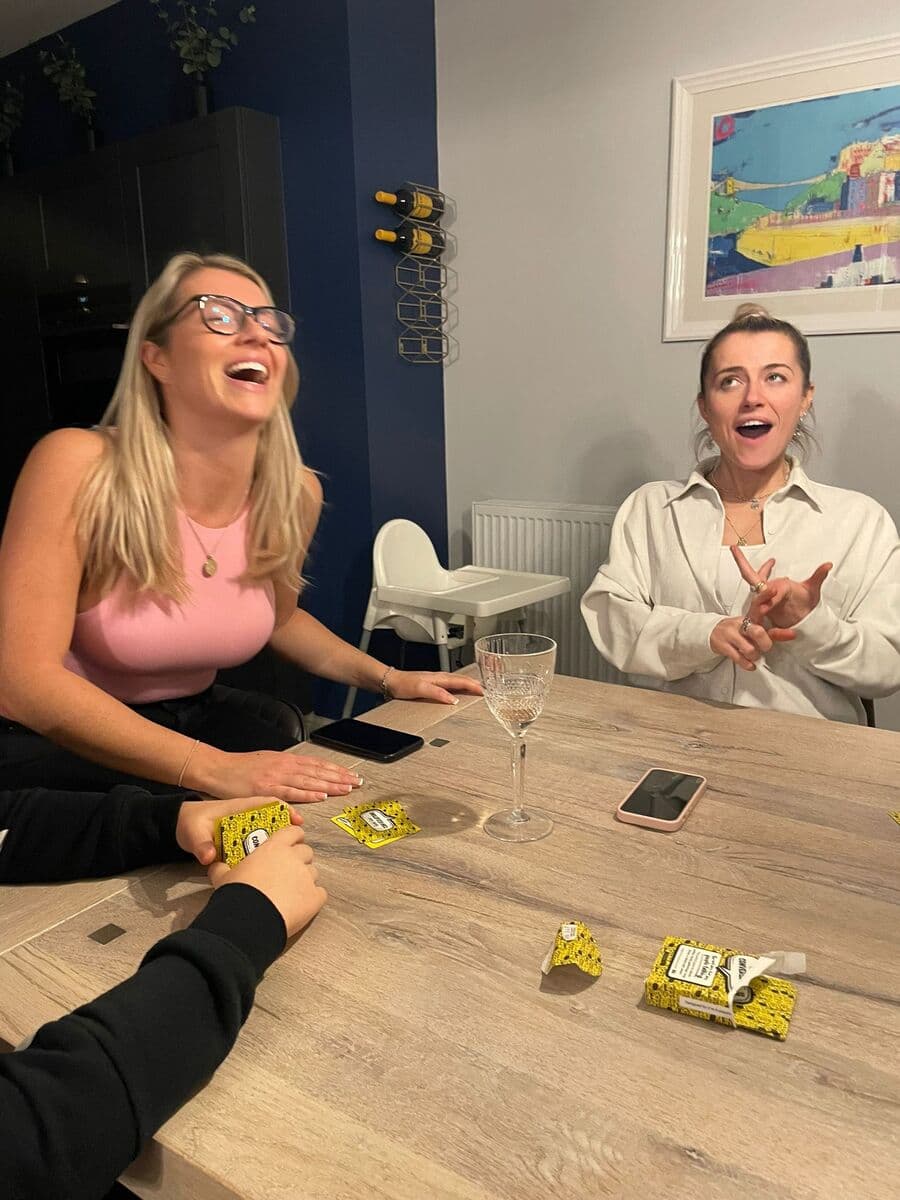 Two women laughing while playing Really Good Conversations